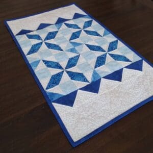 A table runner with blue and white designs on it.