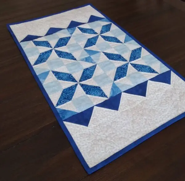 A table runner with blue and white designs on it.