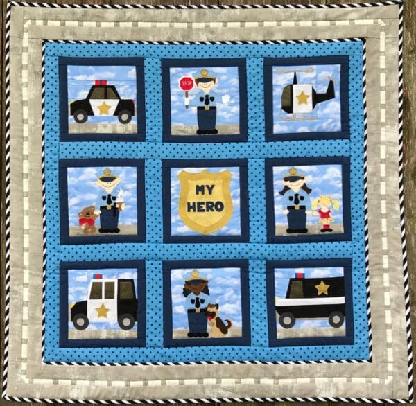 A quilt with police and fire fighters on it.
