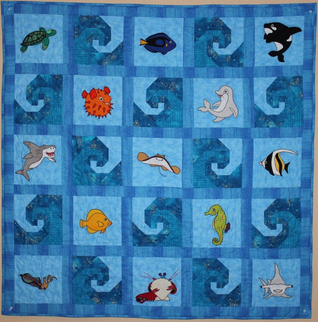 A quilt with sea animals on it.