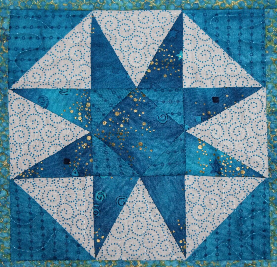 A blue and white quilt with a star on it