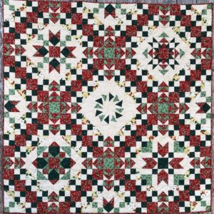 A quilt with red, white and green designs.