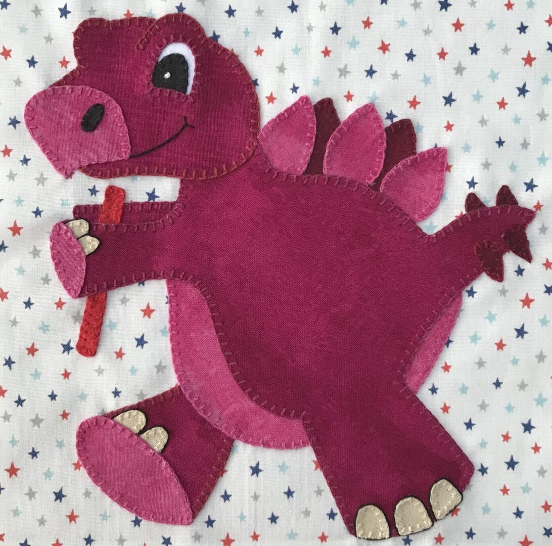 A pink dinosaur holding a toothbrush in its mouth.