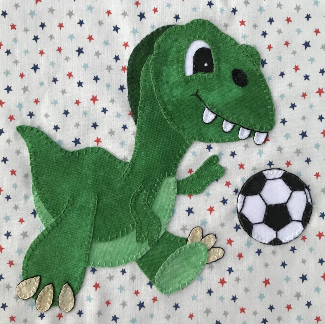 A green dinosaur is playing with a soccer ball.