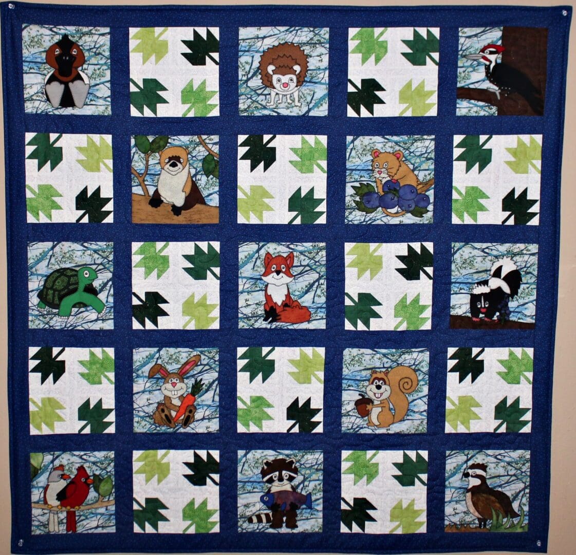 A quilt with pictures of animals and leaves.