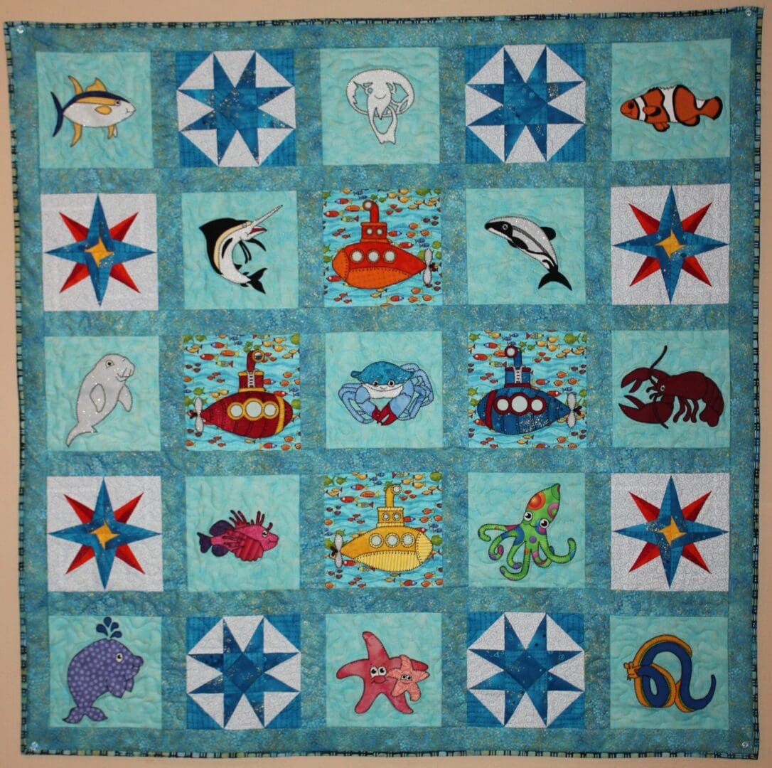 A quilt with sea animals and stars on it.