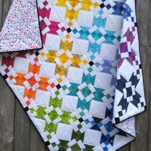 A quilt with different colored stars on it.