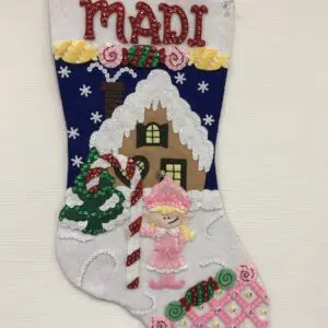 A christmas stocking with a girl in the center.