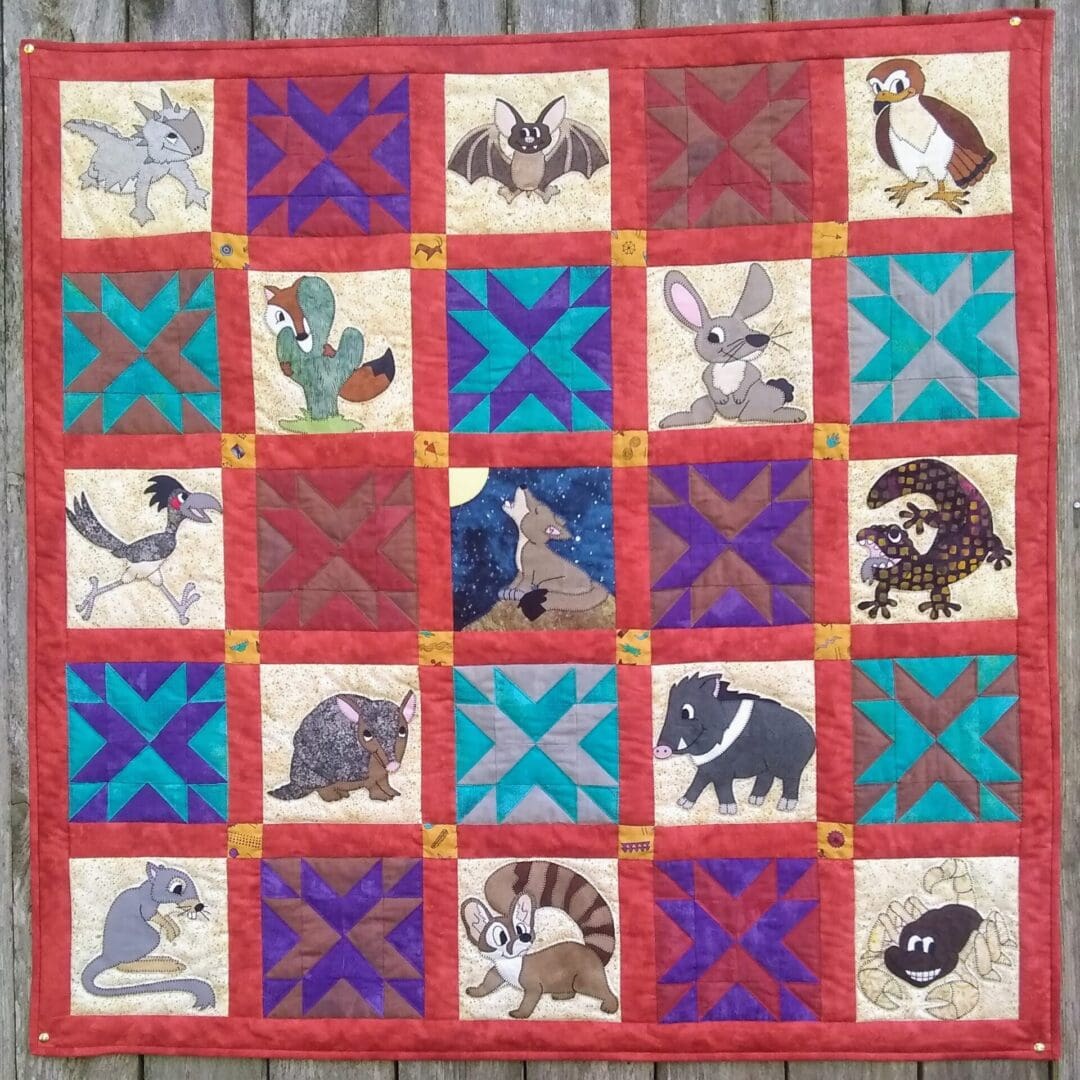 A quilt with animals on it is shown.