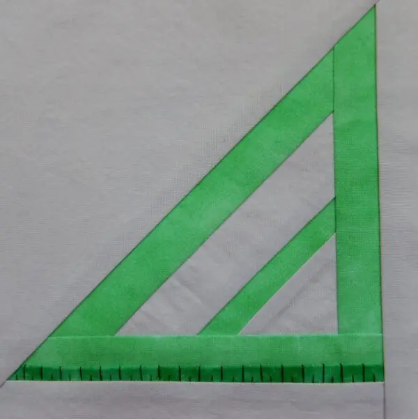 A green triangle with three lines on it.