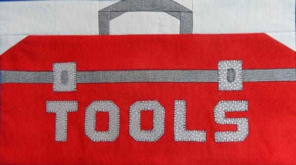 A red tool box with the word tools written on it.