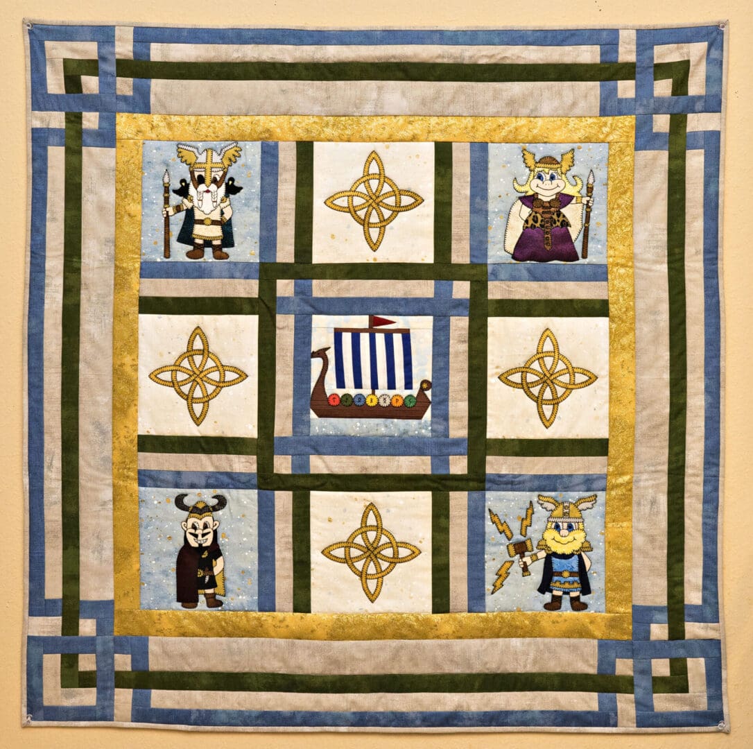 A quilt with viking symbols and animals on it.