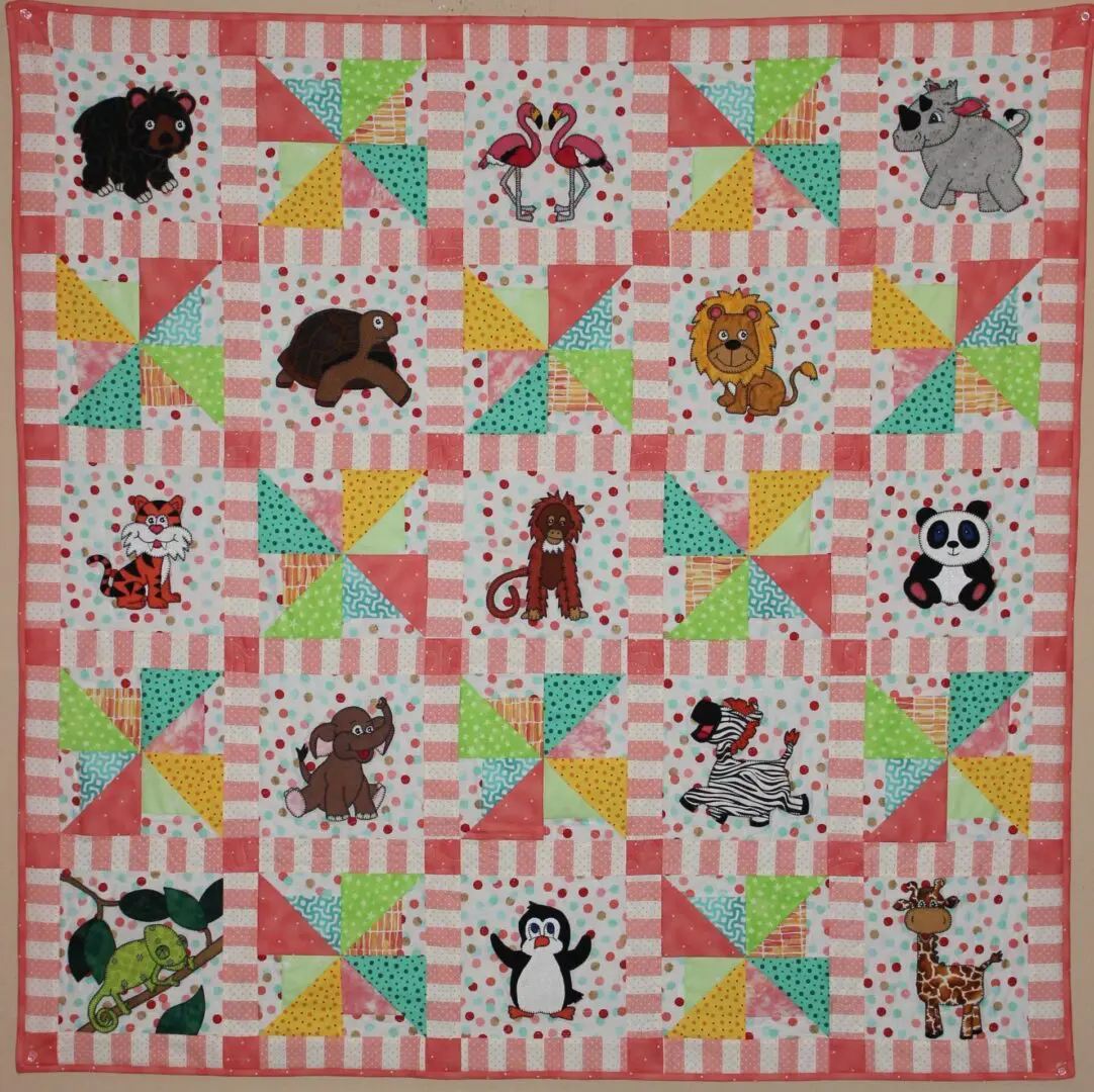 A quilt with animals on it and some of the animal 's names.