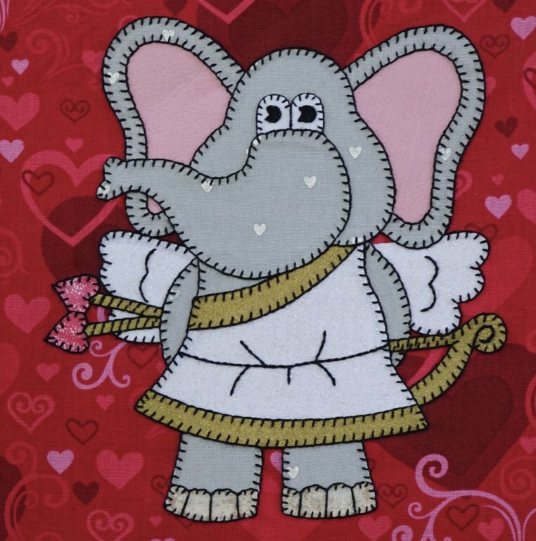 An Elephant - February with wings and hearts on a red background.