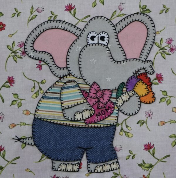 An Elephant - May with a flower in his mouth.