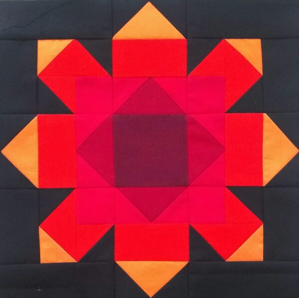 A Firewheel block with red and orange squares.