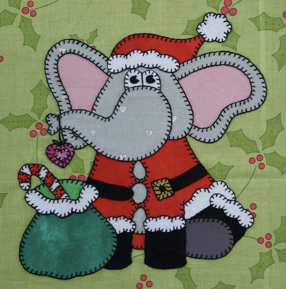 An Elephant - December with a santa hat and candy canes on a green background.