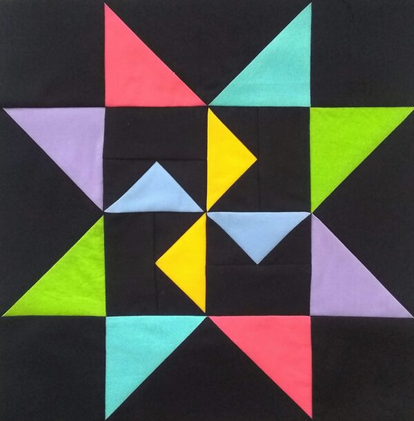 A Martha Washington quilt block with colorful triangles on a black background.