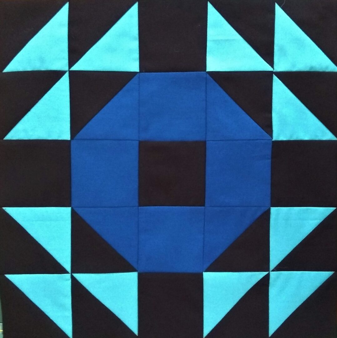 A blue and black Crown of Thorns block on a table.