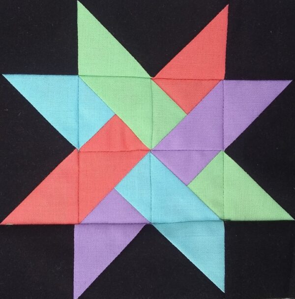 A quilt block with a Woven Star in the middle.