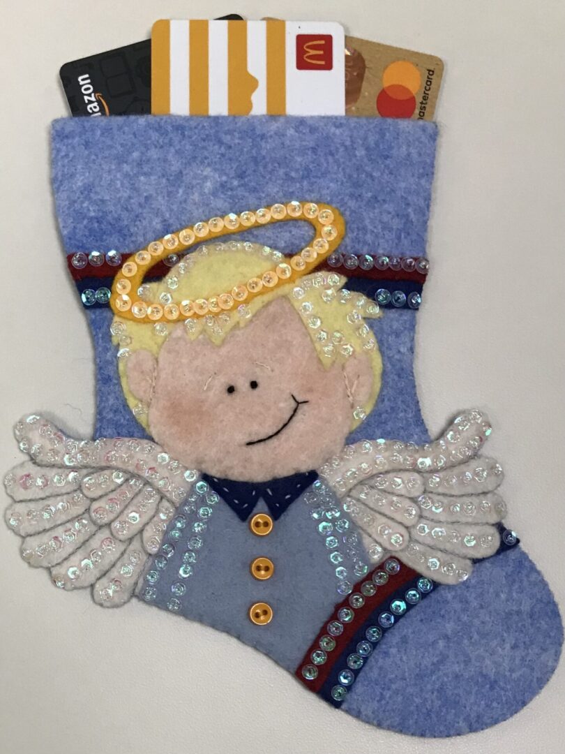 A blue felt stocking with an Angel Boy 1 Gift Card Holder.