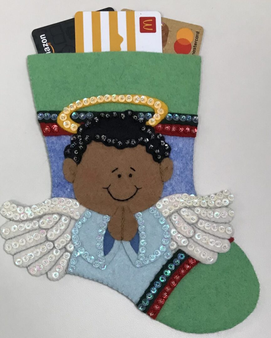 A felt stocking with an Angel Boy 2 Gift Card Holder.