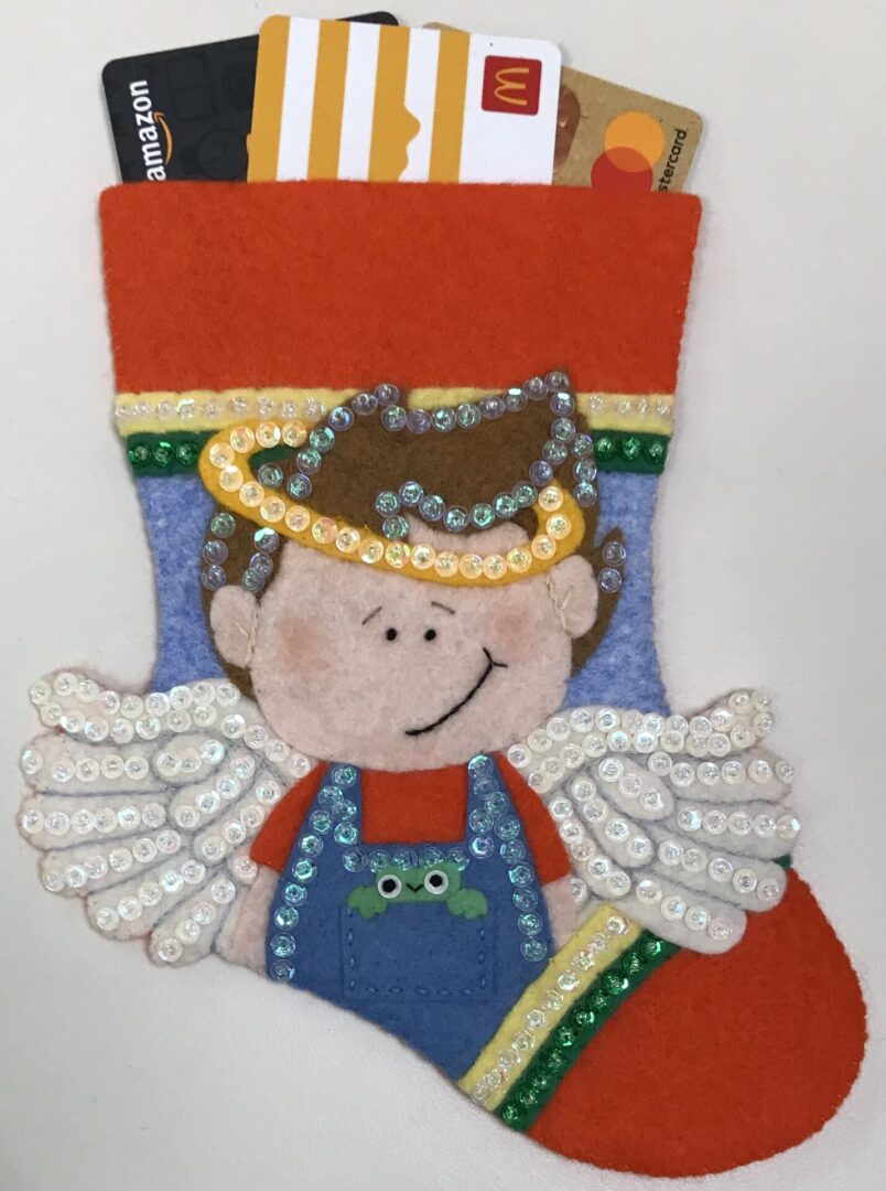 A felt stocking with an Angel Boy 3 Gift Card Holder holding a credit card.
