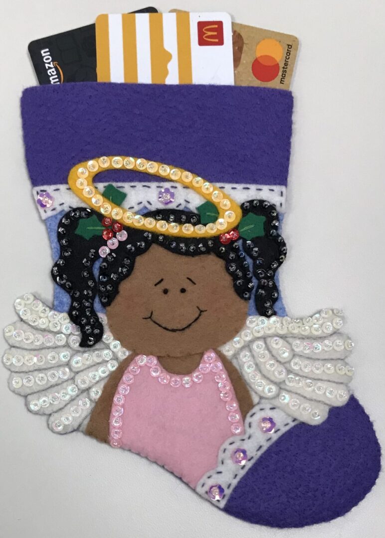 A Christmas stocking with an Angel Girl 2 Gift Card Holder.