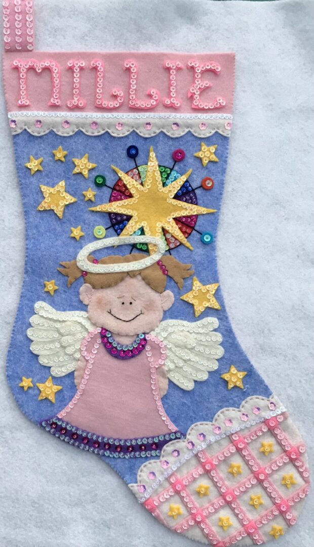 An Angel with Scalloped Trim Stocking with an angel and stars on it.
