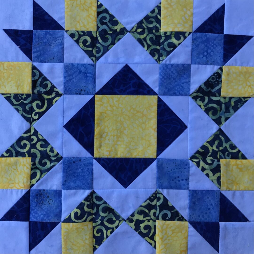 An Arrow and Crown quilt block with a star in the middle.
