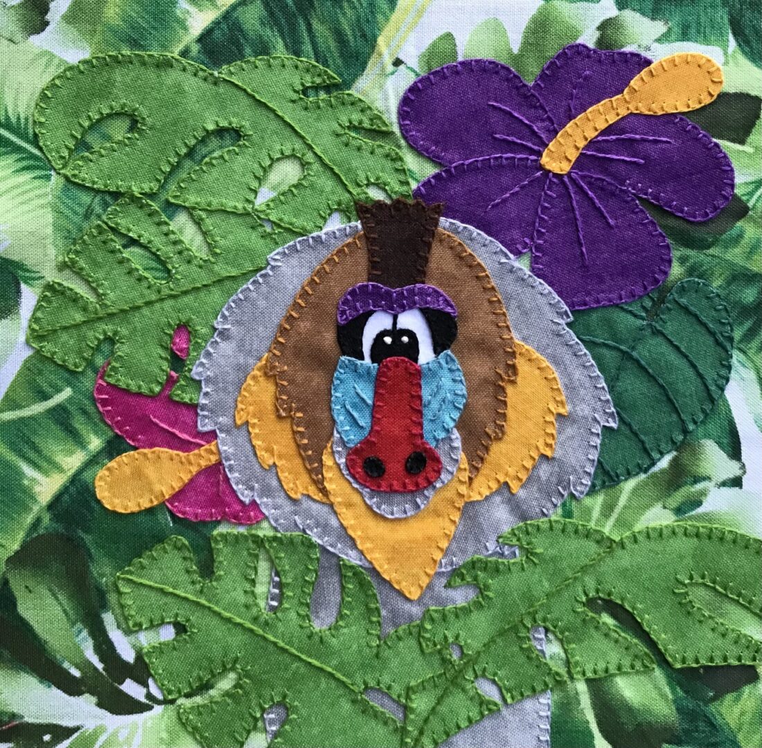 A Baboon applique in a jungle setting.