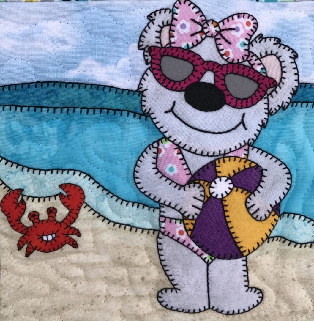 A Beach Ball Bear with sunglasses and a crab on the beach.