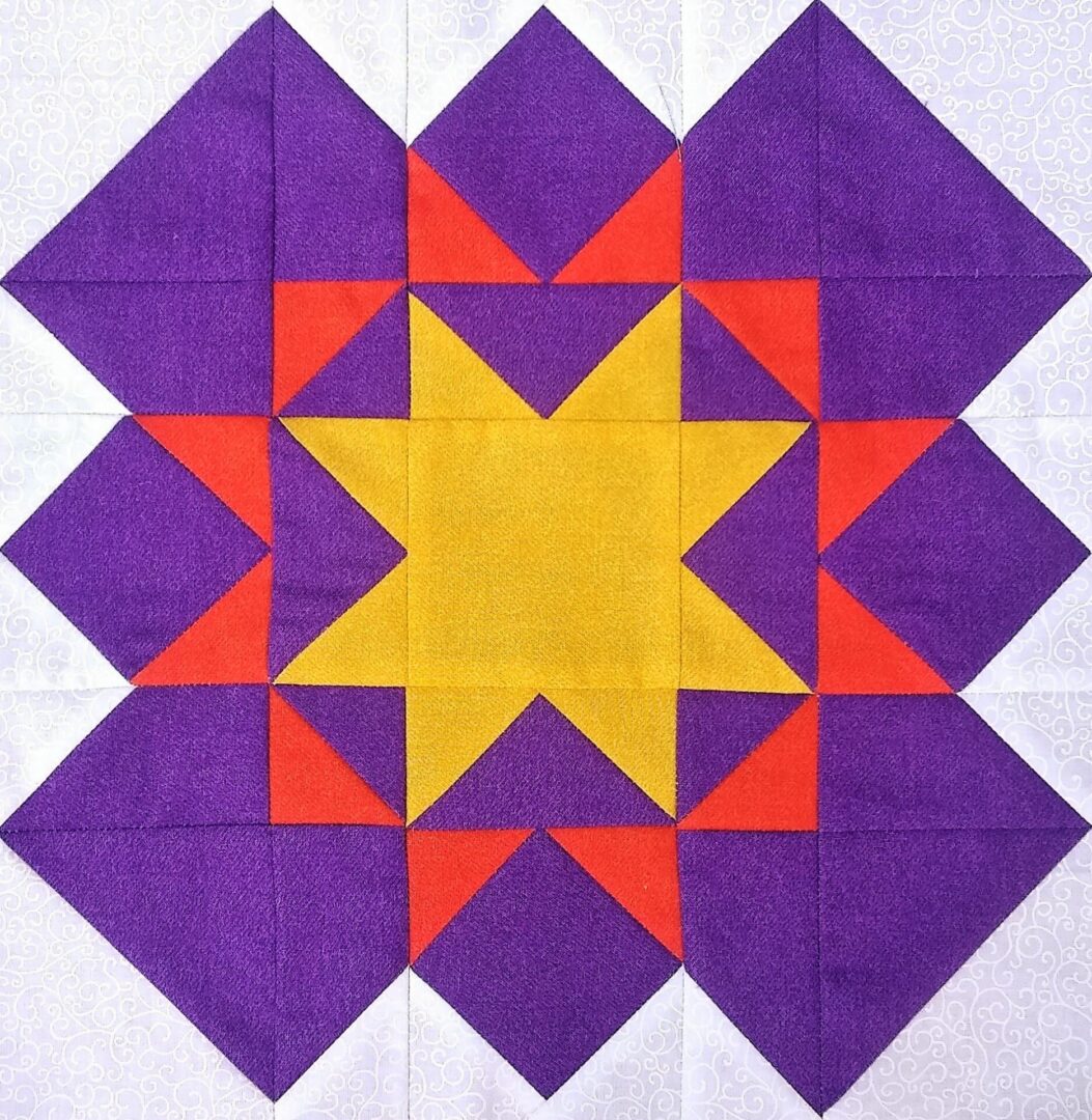 A purple and yellow quilt block with a Blazing Star in the middle.