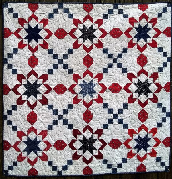 A Celebrations Quilt with red, white and blue stars.