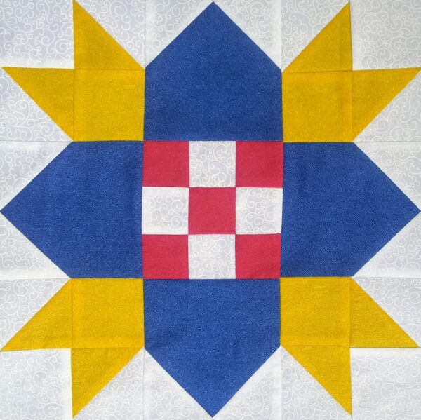 A blue and yellow Checkerboard Star quilt block with a star in the middle.