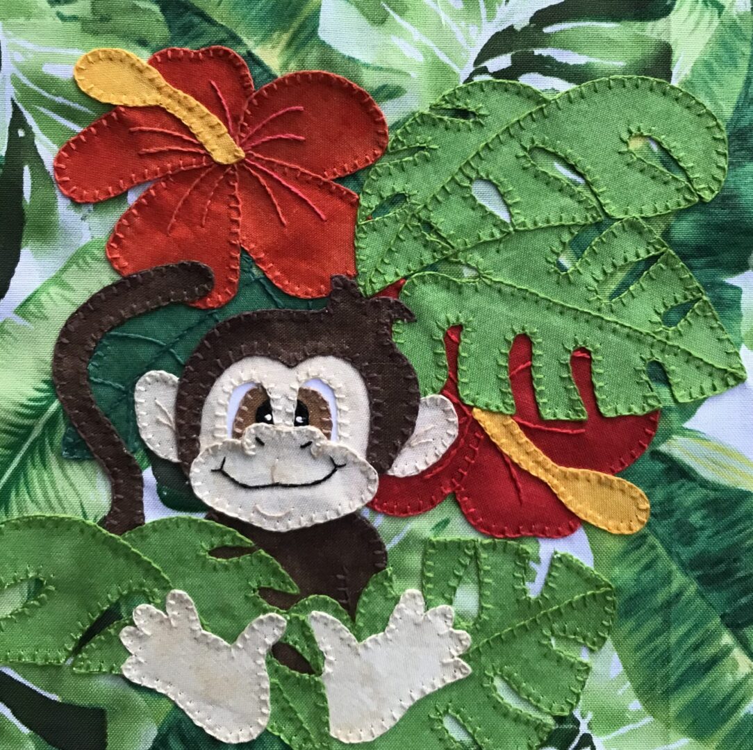 A Chimpanzee with leaves and flowers on a piece of fabric.