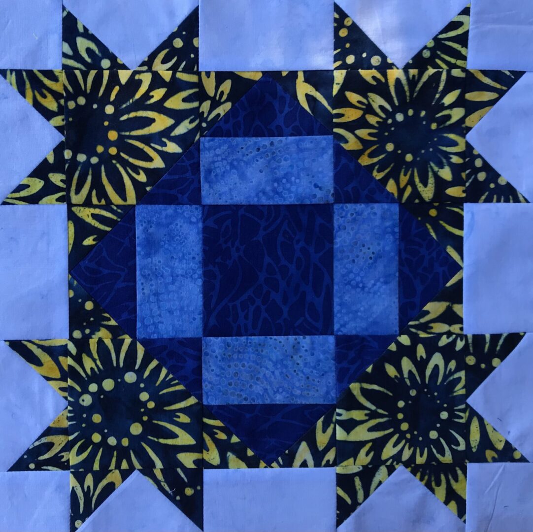 A Clay's Choice quilt block with a star in the middle.