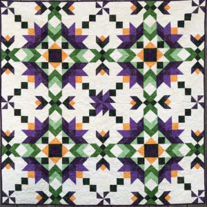 A Cypress Lilies Quilt with purple and green squares.