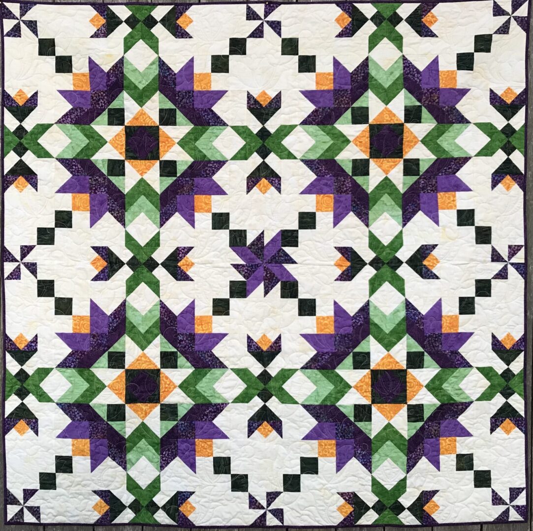 A Cypress Lilies Quilt with purple and green squares.