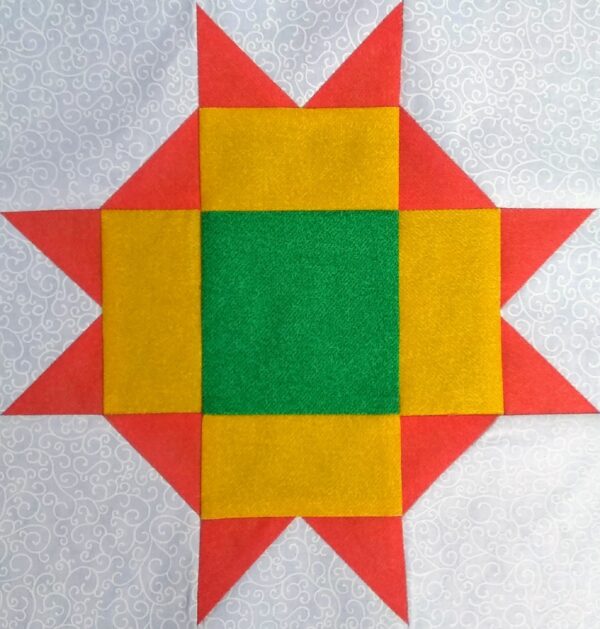 An Easy Star quilt block with red, yellow, and green squares.