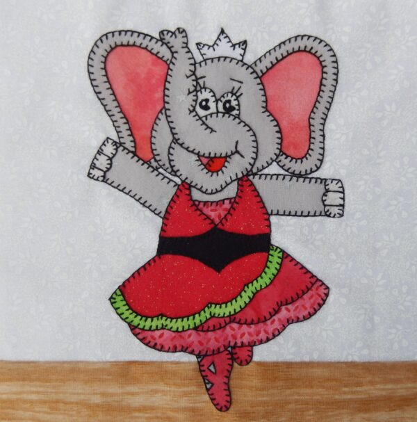 Dance - Elephant in a red dress is appliqued on a piece of fabric.