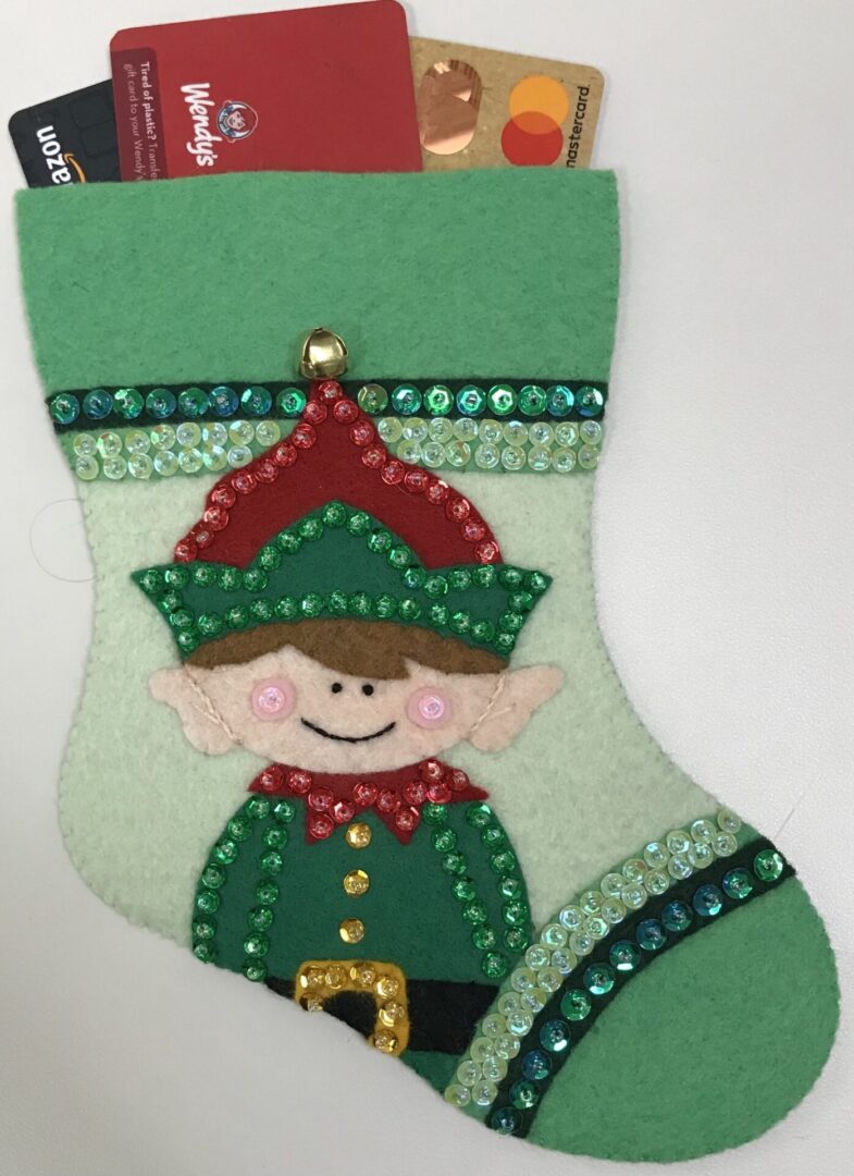 A felt stocking with an Elf Box Gift Card Holder.