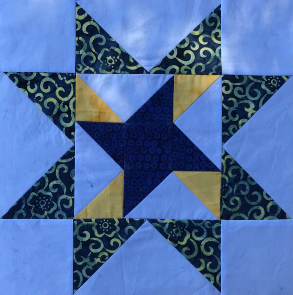 A blue and yellow Fan Waves quilt block.