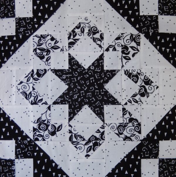 A black and white quilt with Fireworks in the middle.