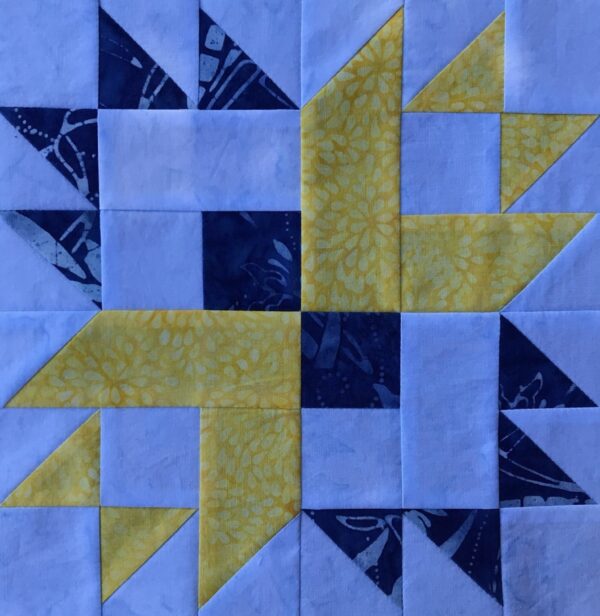 A Four Square Variation block with blue and yellow squares.