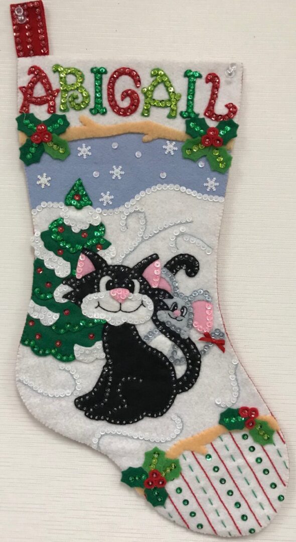A Friendly Kitty Stocking with a black cat and a christmas tree.