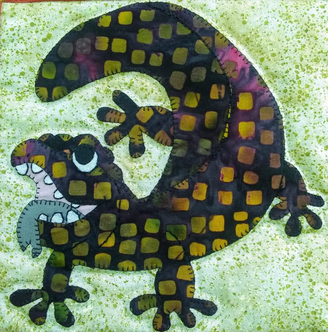 A quilt block with a Gila Monster on it.