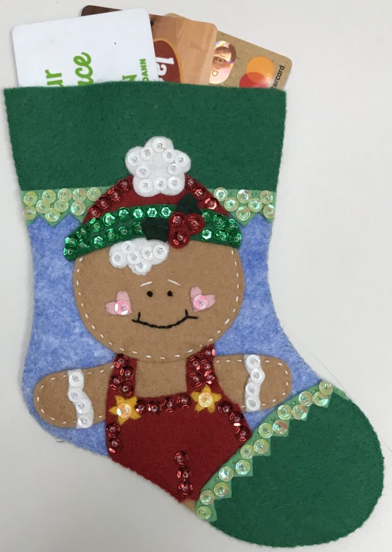 A Christmas stocking with a Gingerbread Boy Gift Card Holder.