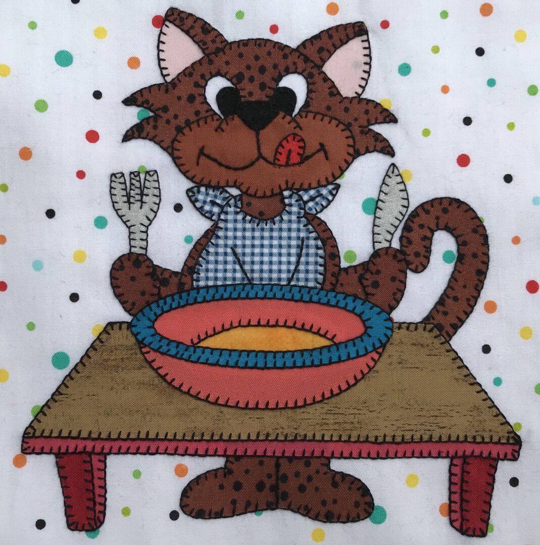 A Hungry Kitty is sitting at a table with a knife and fork.