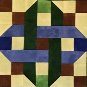 An Interlocking Chain quilt with green, blue and brown squares.